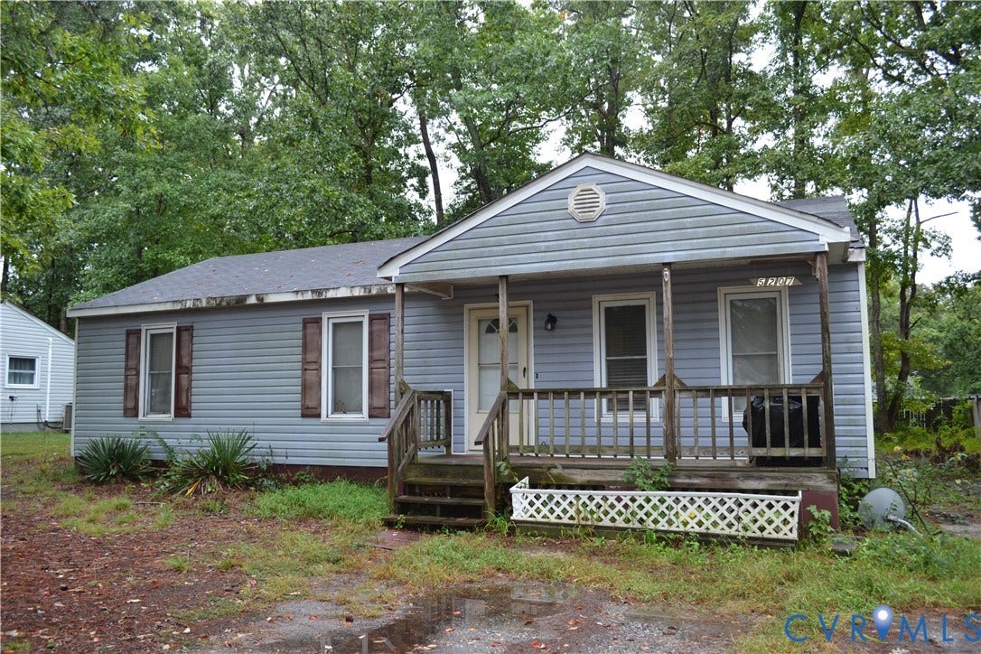 5207 Oakforest Drive, Chesterfield, VA 23832 Light blue vinyl siding exterior with a covered front porch featuring a wood railing