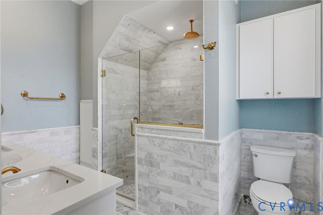 2624 Park Avenue, The Fan District, Richmond, VA 23220 Glass-enclosed shower with tiled walls, rainfall showerhead, and gold-toned fixtures