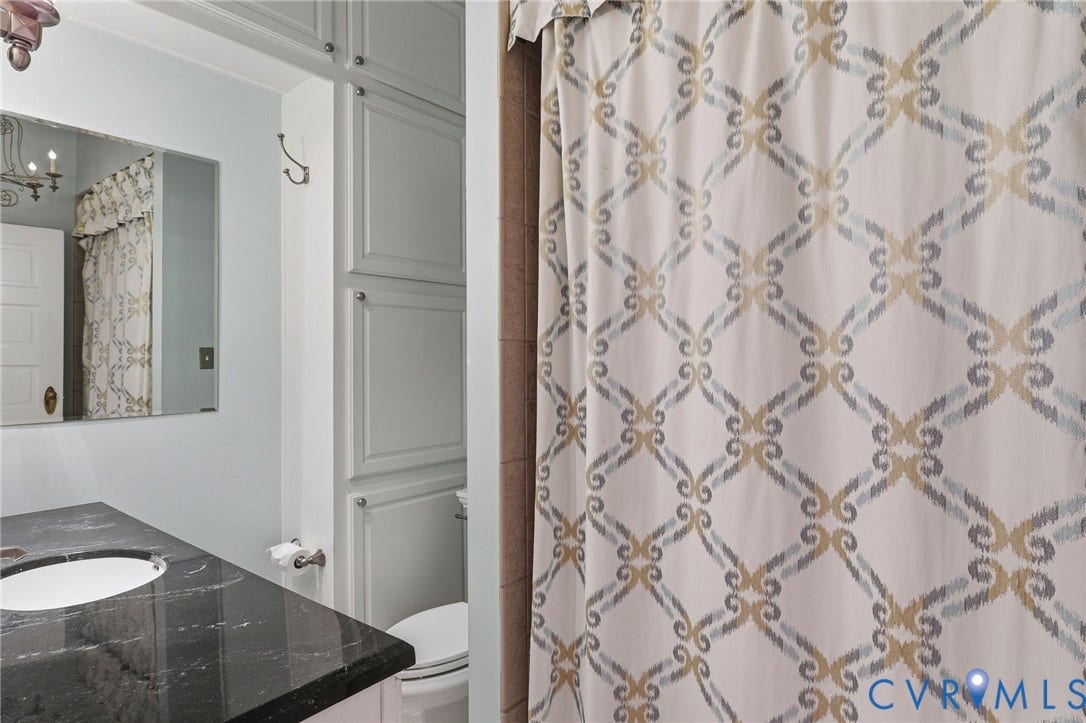 2624 Park Avenue, The Fan District, Richmond, VA 23220 Built-in cabinetry with paneling, integrated vanity sink, polished black countertop, and recessed lighting