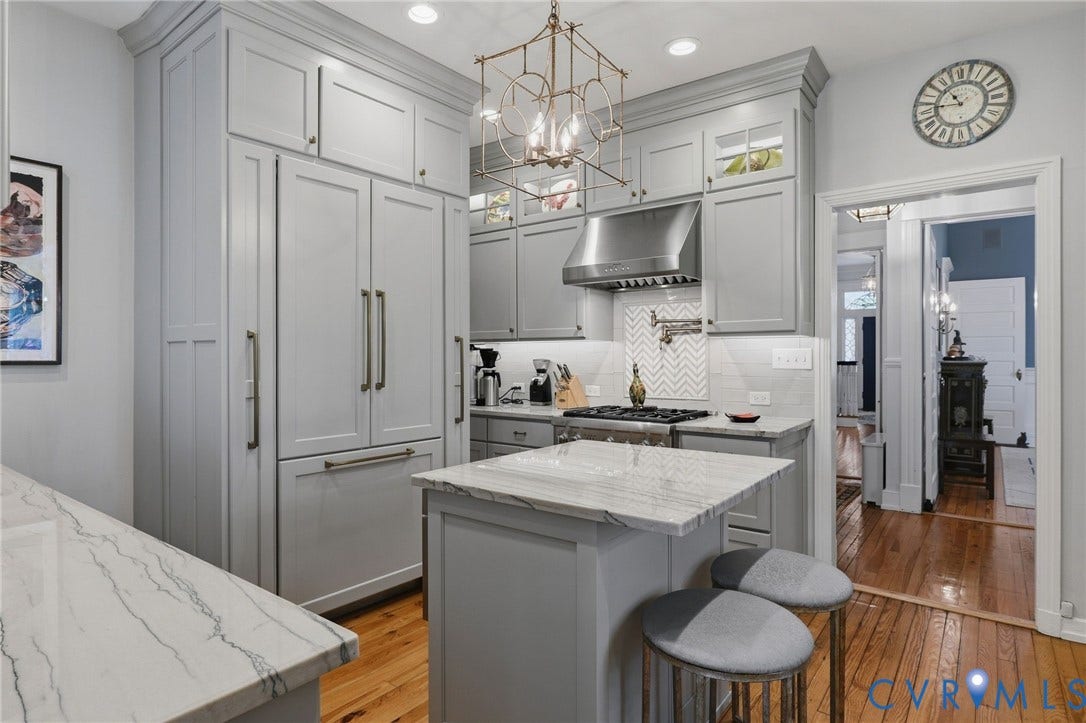 2624 Park Avenue, The Fan District, Richmond, VA 23220 Kitchen featuring light gray cabinetry, built-in panel-front refrigerator, stainless Thermador appliances, steel range hood, white subway tile backsplash, quartz and breakfast island