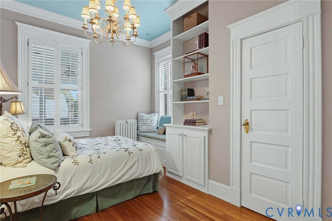 2624 Park Avenue, The Fan District, Richmond, VA 23220 Hardwood flooring, built-in shelving with lower cabinetry, window seat with storage, decorative ceiling chandelier, and paneled interior door