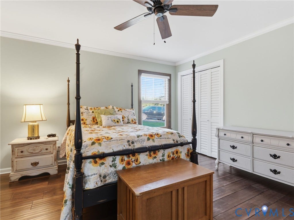 16233 Pleasant Mill Road, Montpelier, VA 23192 Neutral wall palette with crown molding, wood-finish flooring, ceiling fan with light fixture, and bi-fold closet doors