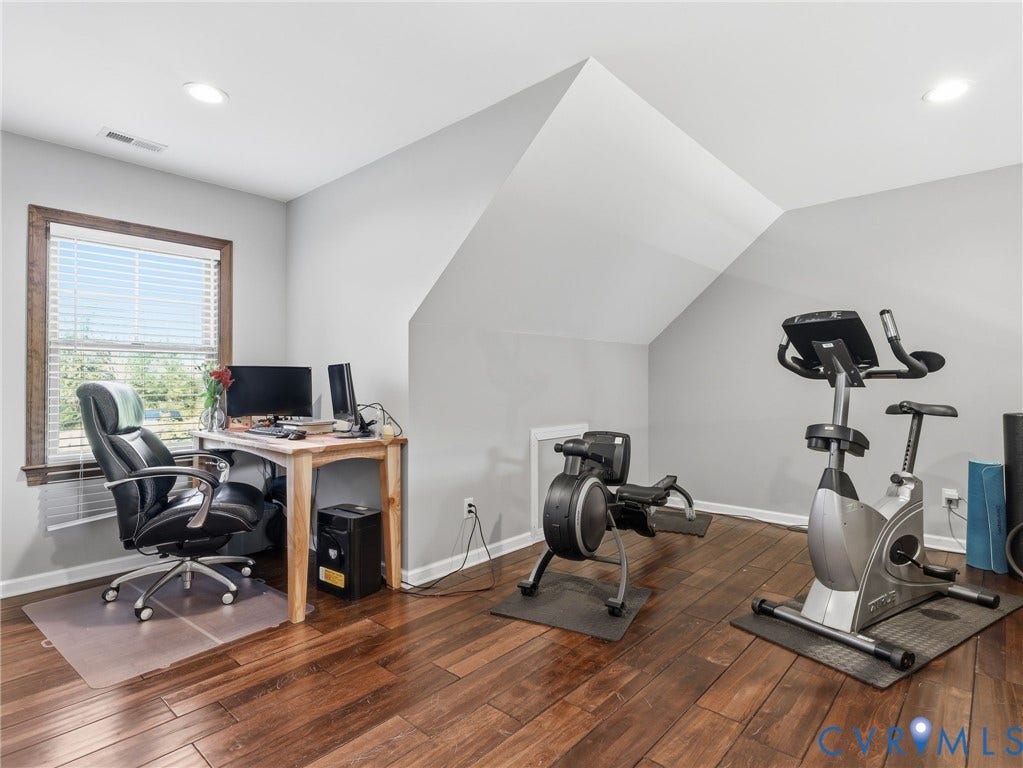 16233 Pleasant Mill Road, Montpelier, VA 23192 Wood-finish flooring, recessed lighting, and a window with dark wood trim in a room featuring vaulted ceilings