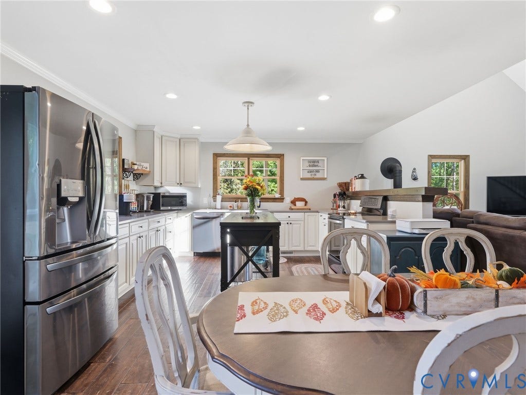16233 Pleasant Mill Road, Montpelier, VA 23192 Kitchen featuring wood-finish flooring, white cabinetry, stainless steel appliances, a center island with a dark finish, and recessed ceiling lighting