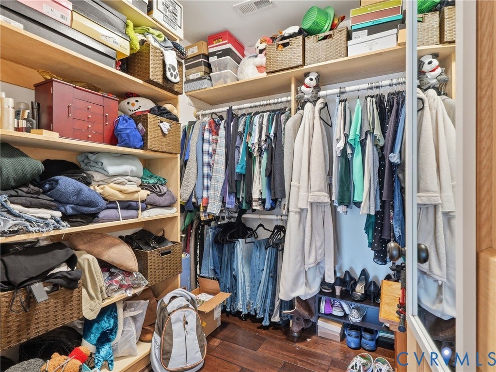 16233 Pleasant Mill Road, Montpelier, VA 23192 Walk-in closet featuring multi-tiered wood-finish shelving, overhead storage compartments, integrated hanging rods, and wood-finish flooring