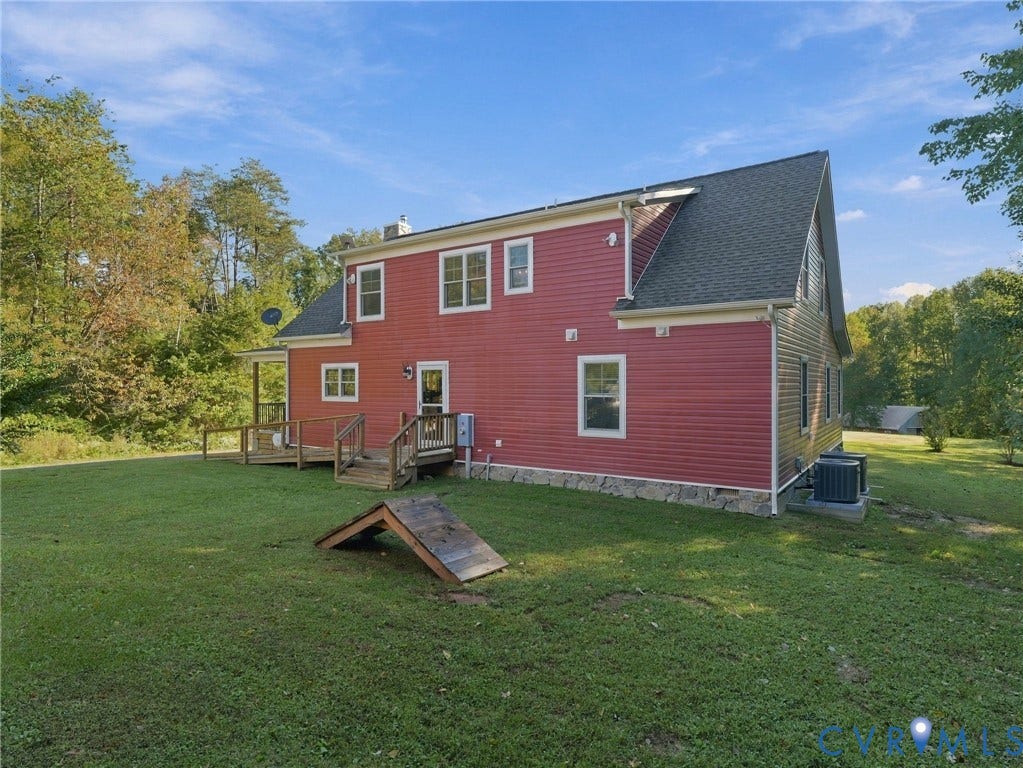 16233 Pleasant Mill Road, Montpelier, VA 23192 Red siding exterior featuring a stone foundation, asphalt shingle roof, wood deck with stairs, and multiple multi-pane windows