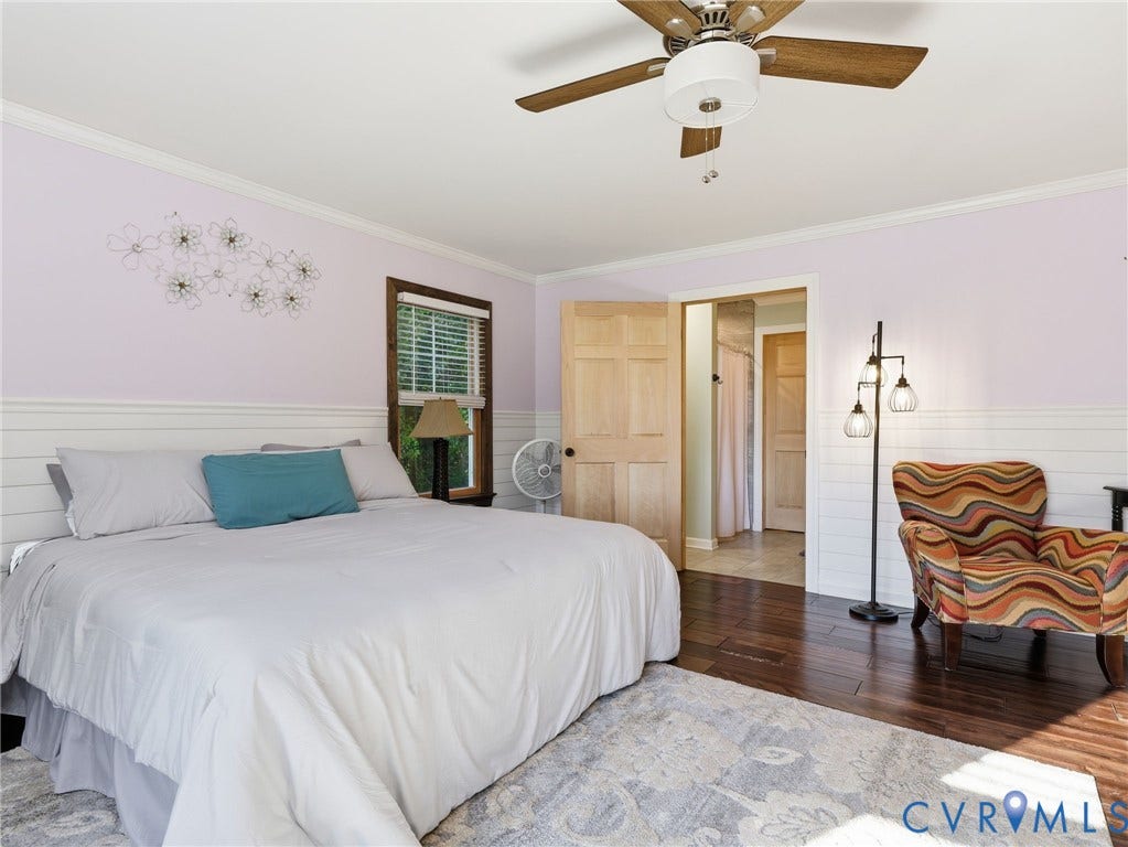 16233 Pleasant Mill Road, Montpelier, VA 23192 Room featuring dark-stained wood-finish flooring, horizontal shiplap wall paneling, crown molding, and a central ceiling fan with integrated lighting