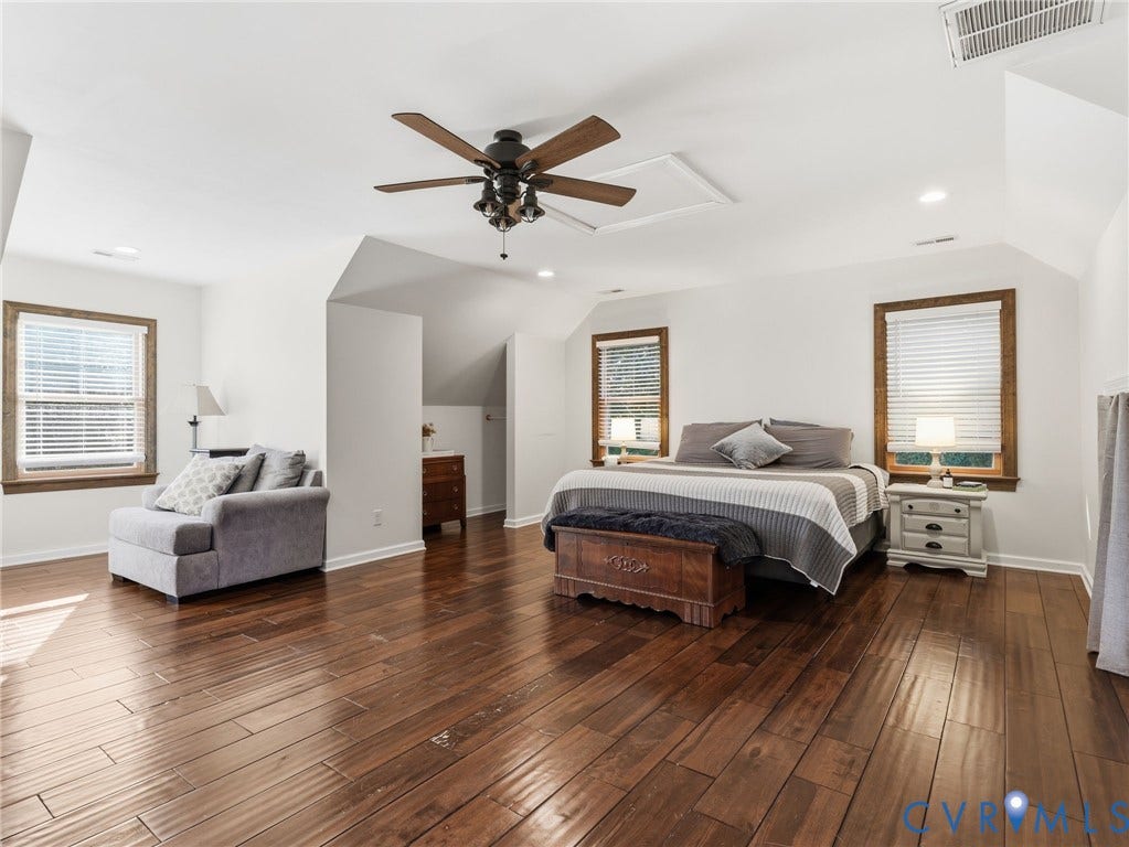 16233 Pleasant Mill Road, Montpelier, VA 23192 Spacious room featuring wood-finish flooring, vaulted ceilings, a central ceiling fan with integrated lighting, and multiple windows framed by wood trim