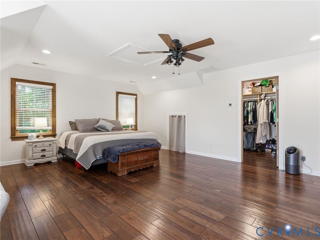 16233 Pleasant Mill Road, Montpelier, VA 23192 Spacious room featuring wood-finish flooring, vaulted ceilings, recessed lighting, a ceiling fan, and built-in wall storage access