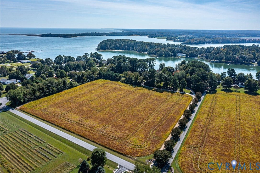 Expansive acreage offering direct water access and surrounded by mature trees. Bring your horses