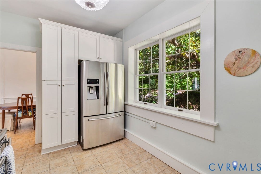 Guest Cottage-White cabinetry with polished hardware, tiled flooring, and a large multi-pane window