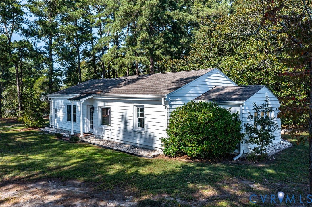 White exterior siding with a dark asphalt shingle roof