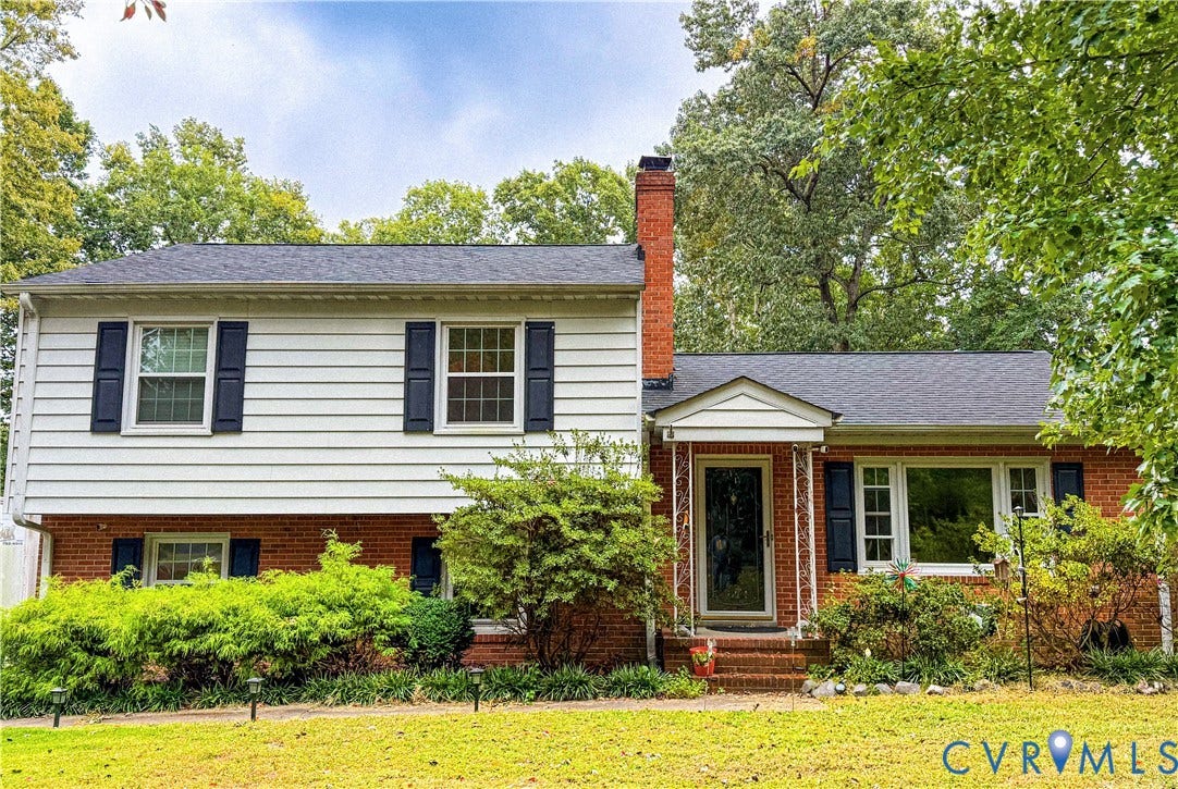 9731 Stagpenn Road, Deerfield Estates, Chesterfield, VA 23832 Brick and siding exterior with dark shutters,
covered entry, and a prominent brick chimney