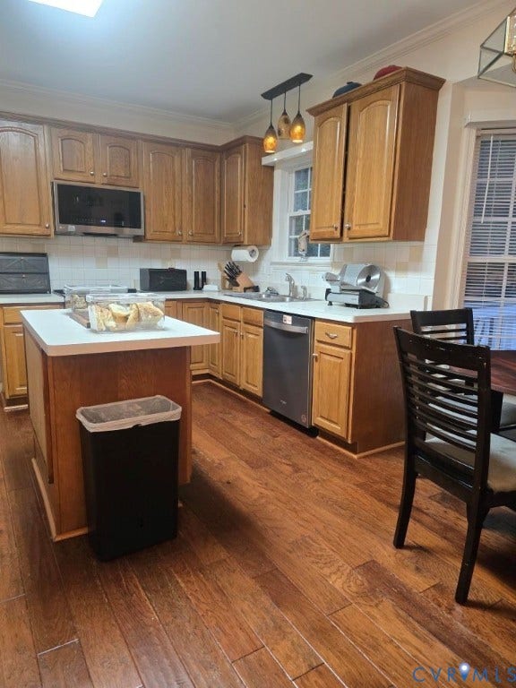 Wood-finish flooring throughout, complemented by wood cabinetry and white countertops