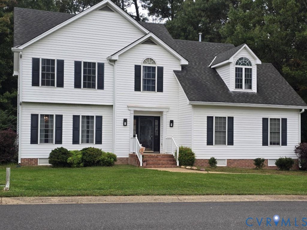 Two-story residence featuring white siding and a dark shingle roof