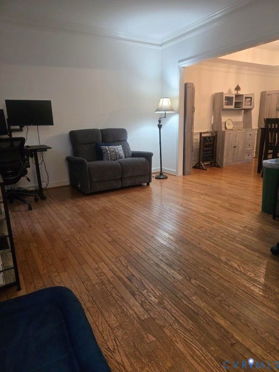 Hardwood flooring throughout, with crisp white walls and crown molding