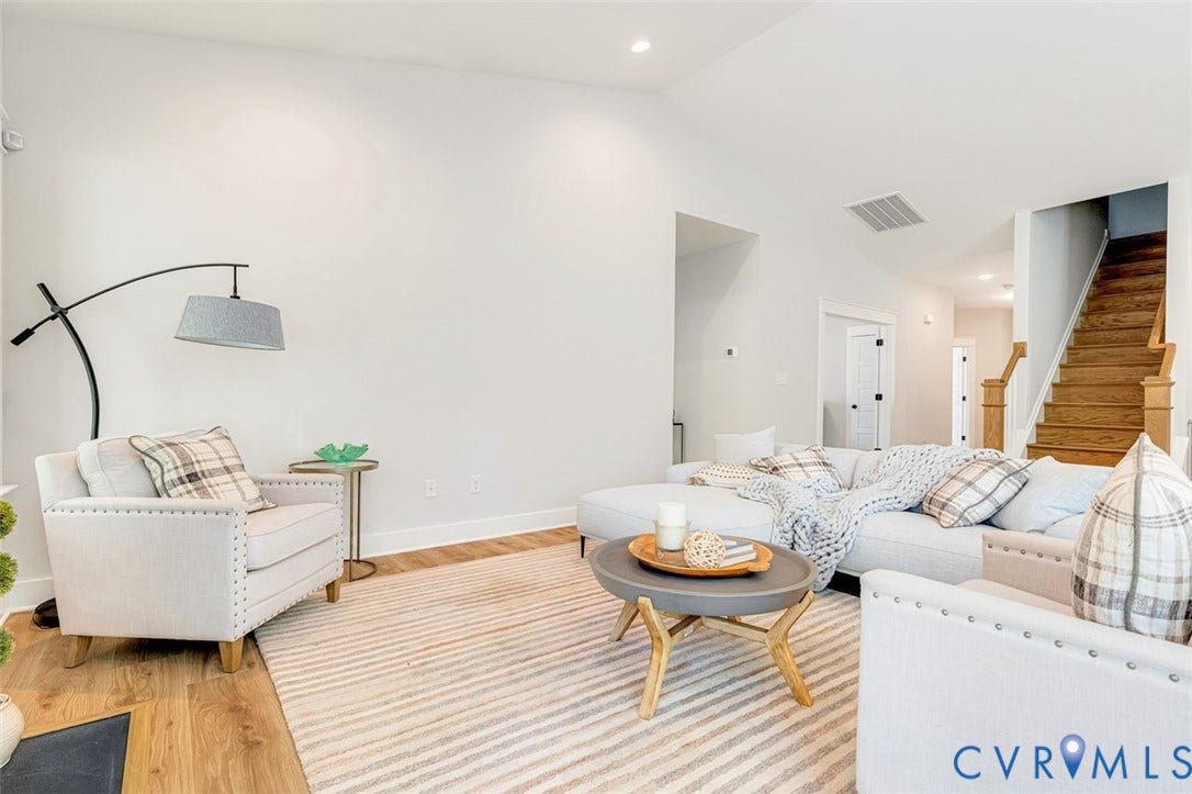 Vaulted ceiling, recessed lighting, wood-finish flooring, wood staircase, and white interior doors