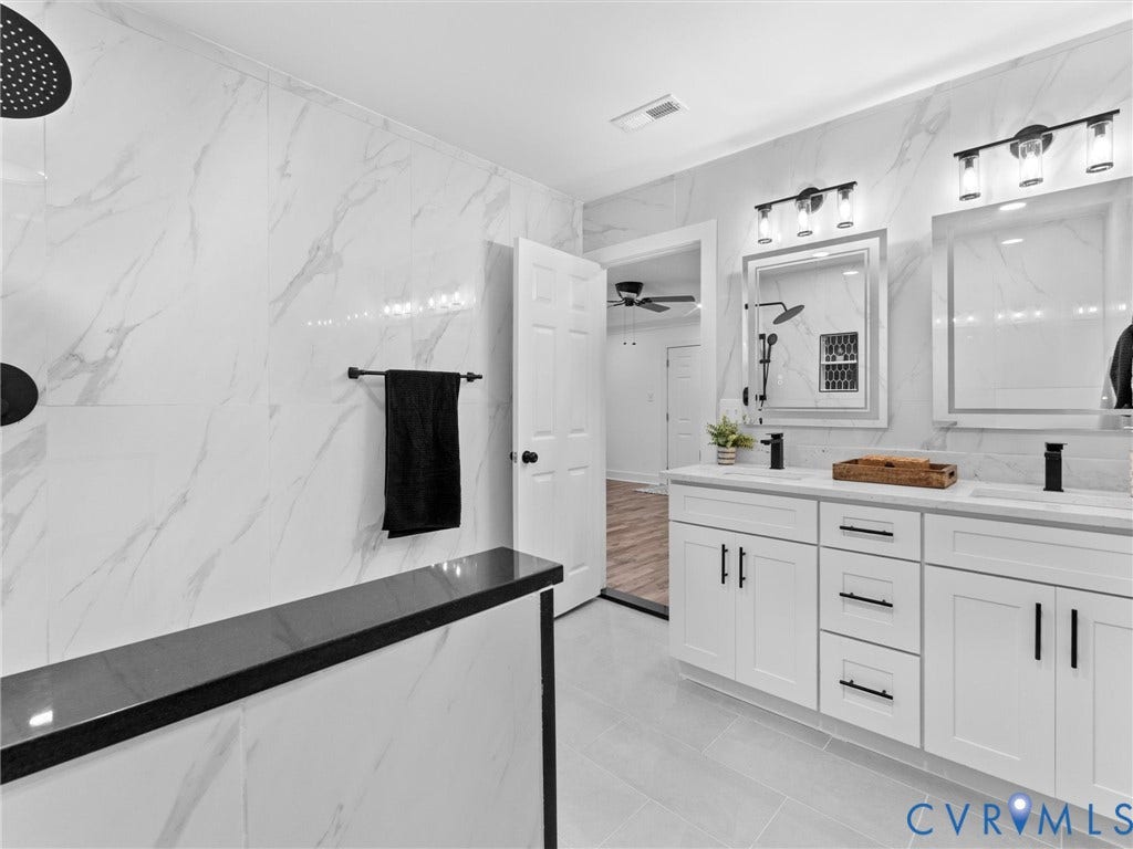 Dual vanity with white cabinetry and black hardware