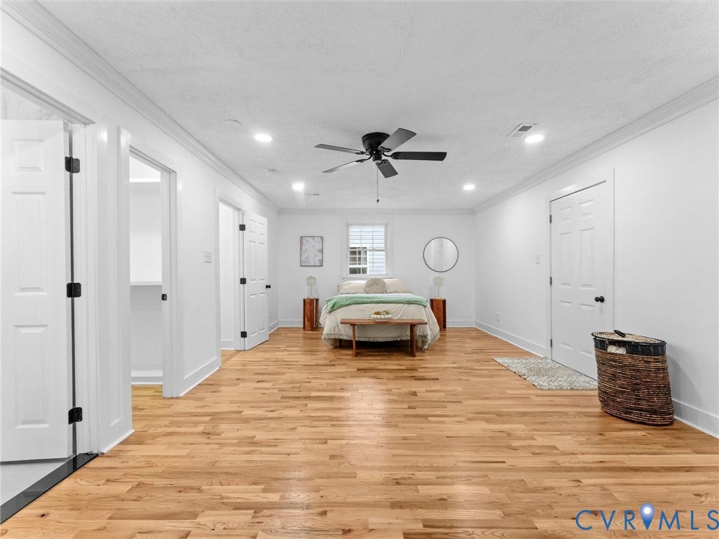Expansive room featuring wood-finish flooring, recessed lighting, and a ceiling fan