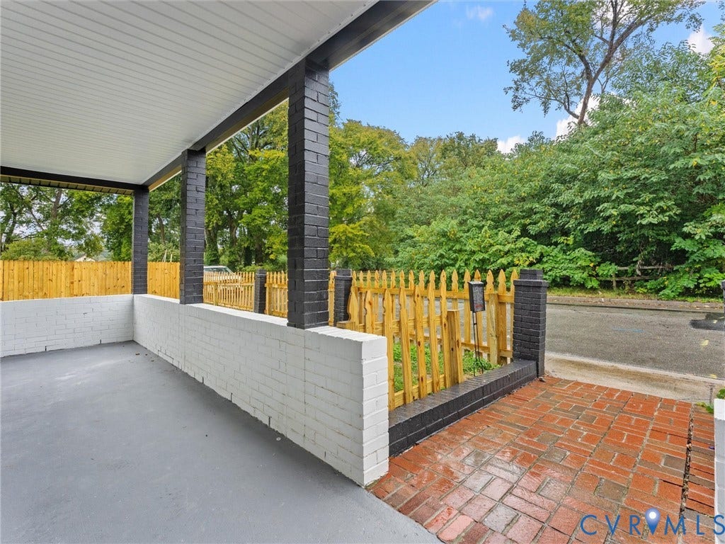 Covered front porch with painted brick columns and a painted brick half-wall