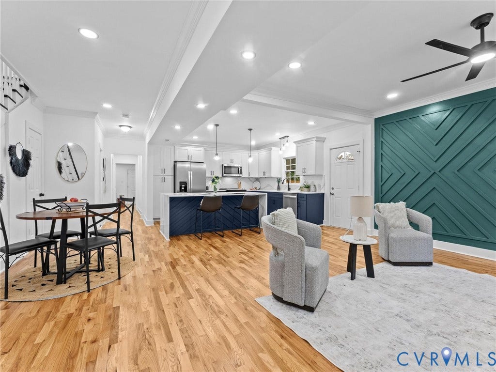 Open-concept living space featuring wood-finish flooring and recessed lighting