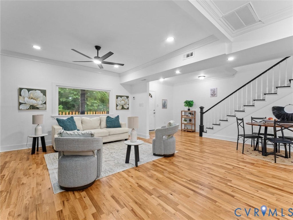 Open-concept living space featuring wood-finish flooring, recessed lighting, and a modern ceiling fan