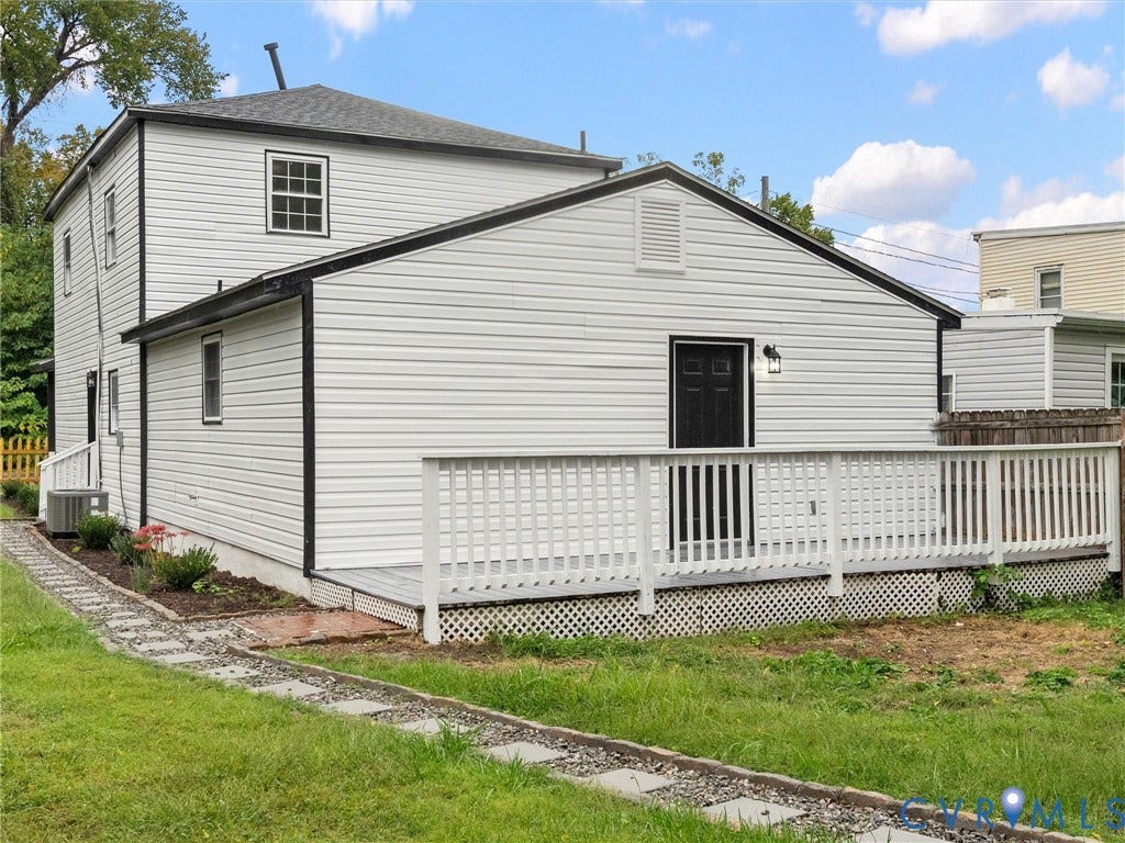 White vinyl siding exterior with a black trim roofline