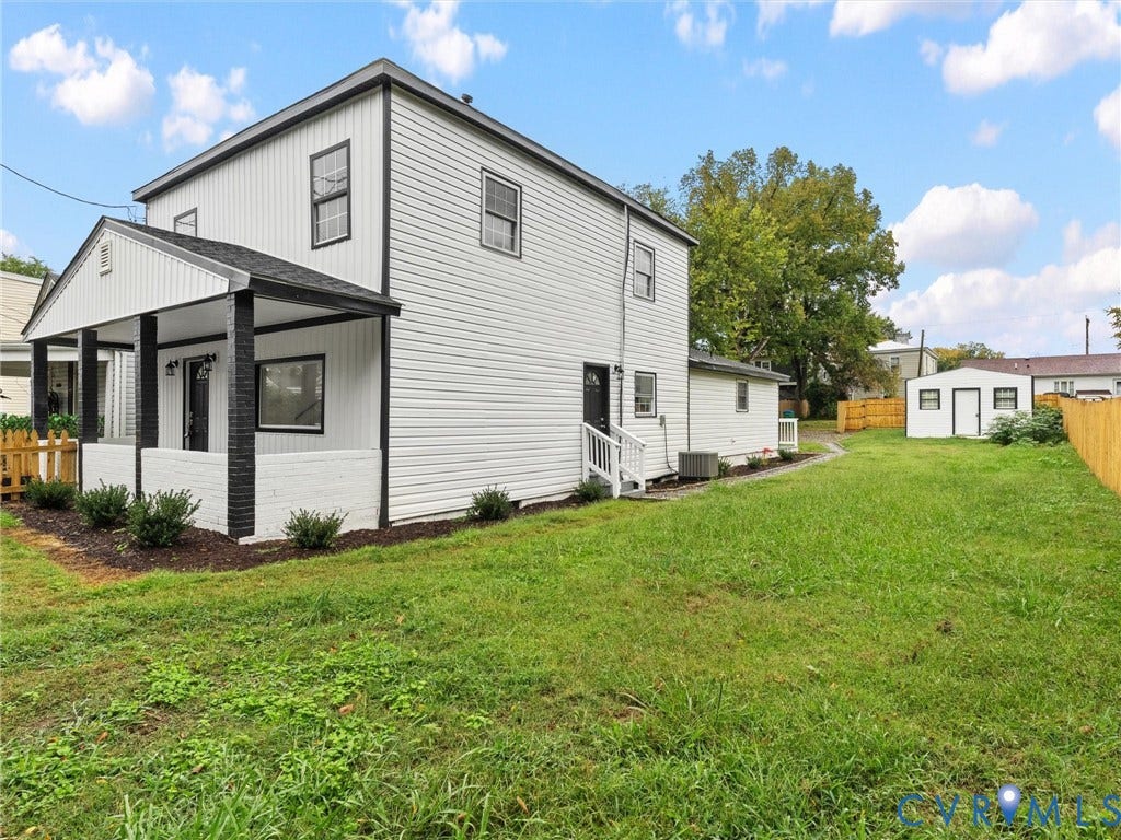 Two-story residence with white siding and black trim accents