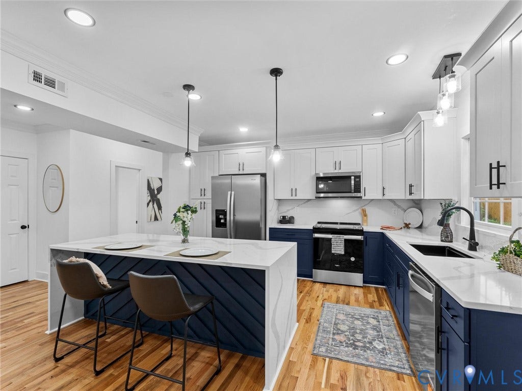 Kitchen featuring wood-finish flooring, recessed lighting, and a center island with pendant lights