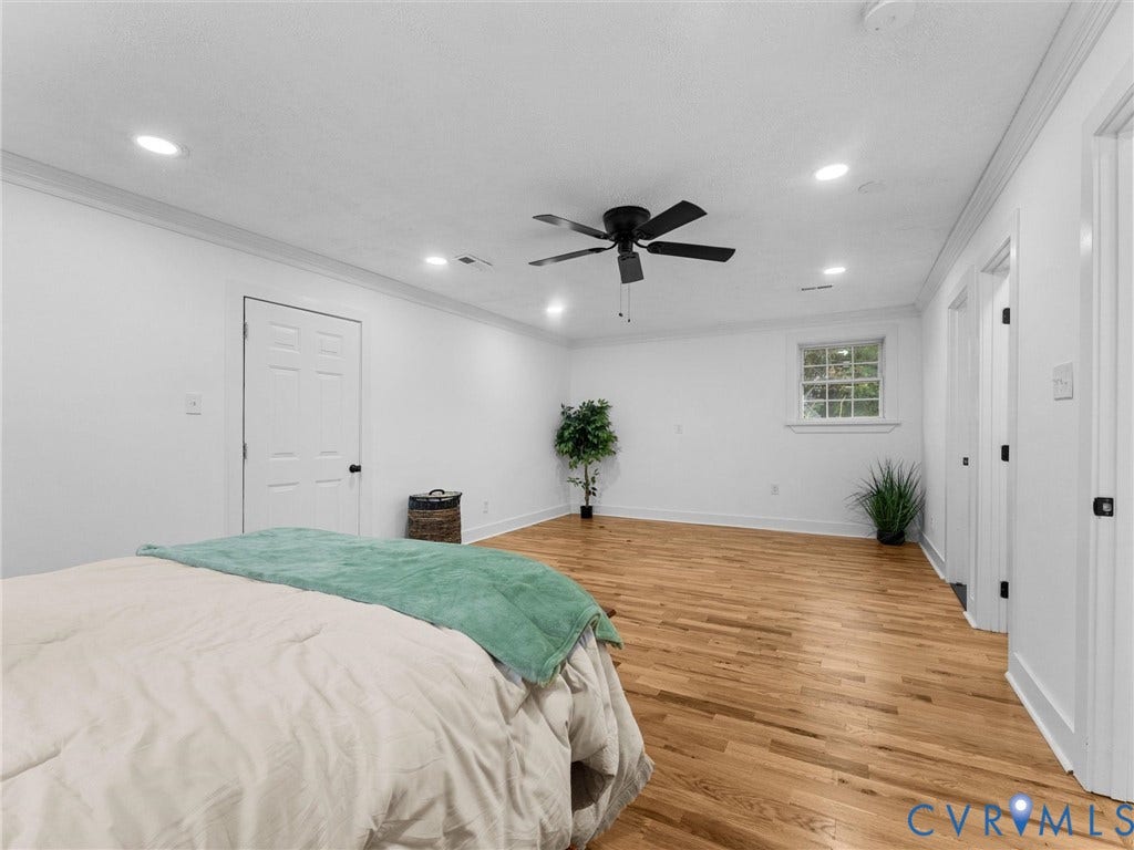 Hardwood flooring, recessed lighting, ceiling fan, white trim, and a window with natural light