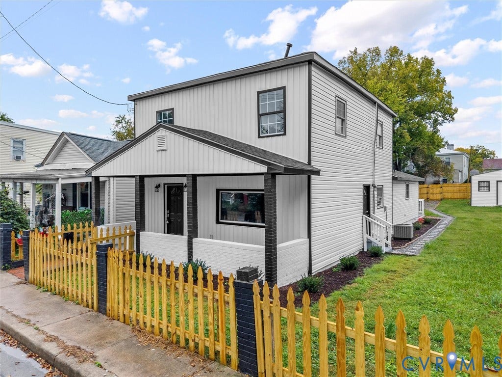 Two-story exterior with white siding and black trim accents