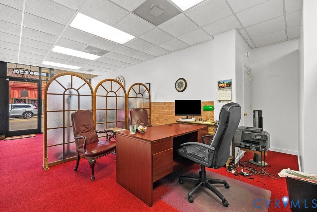 Recessed lighting, red carpeting, white walls, full-light entry door, and a dropped ceiling with acoustic tiles
