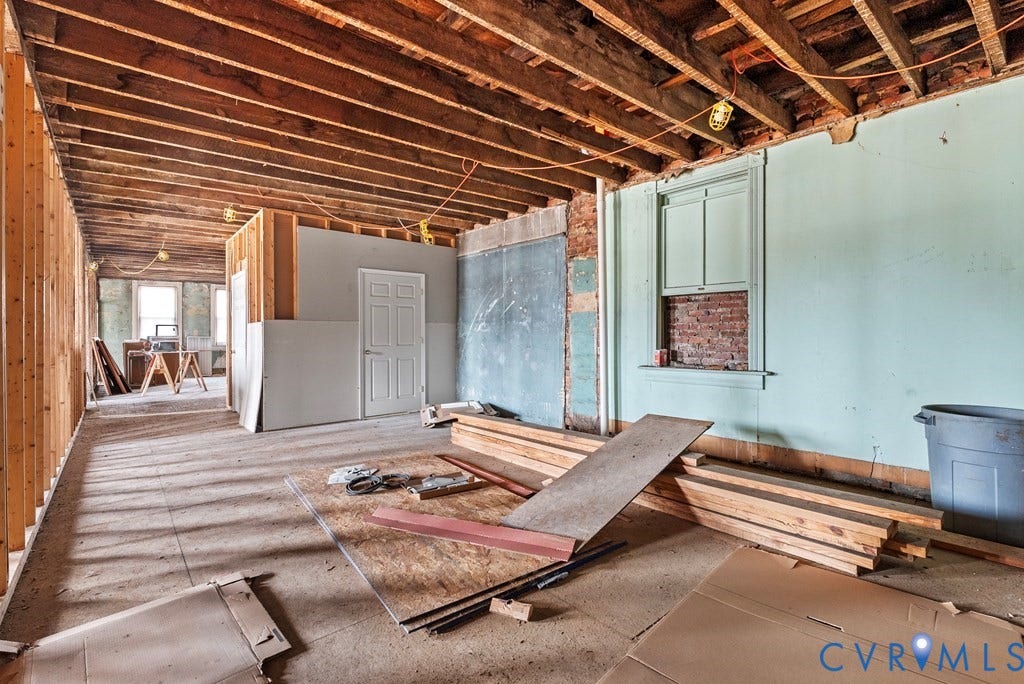 Exposed ceiling joists and wall studs revealing structural elements