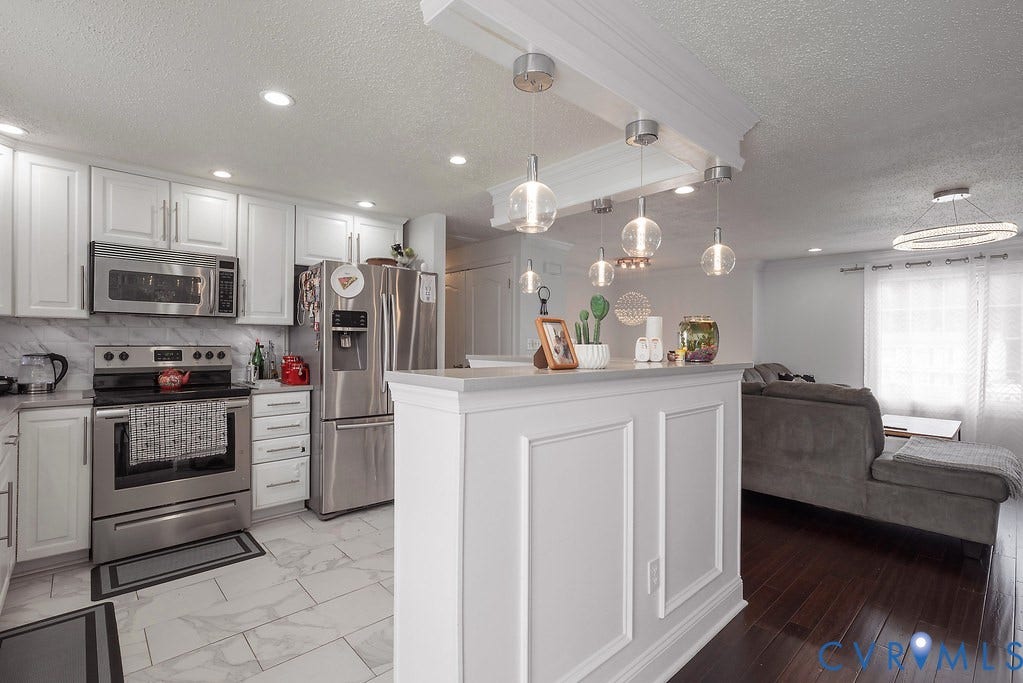 White shaker-style cabinetry with stainless steel hardware