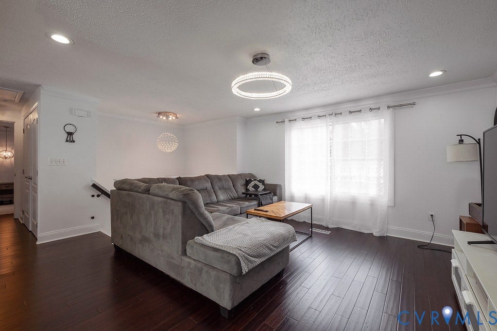 Hardwood-style flooring throughout, white interior doors, and a built-in spherical light fixture