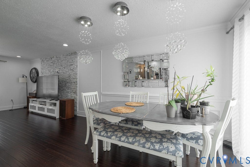 Recessed lighting, wood-finish flooring, and a decorative accent wall