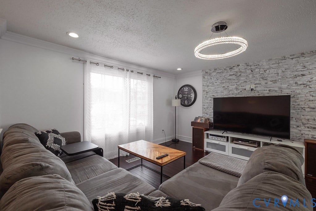 Hardwood-finish flooring throughout, recessed lighting, and contemporary light fixtures