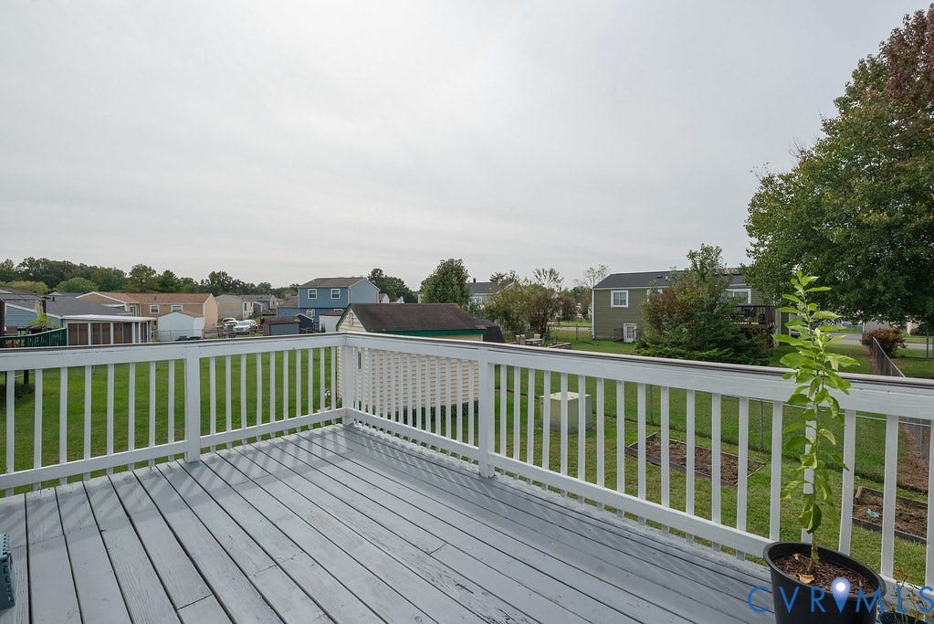 Outdoor deck with painted wood-finish flooring and white railing
