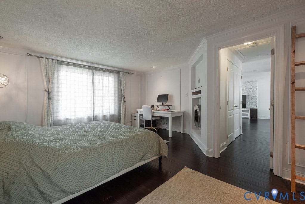 White kitchen cabinetry with stainless steel appliances, marble-look tile flooring, and integrated recessed lighting