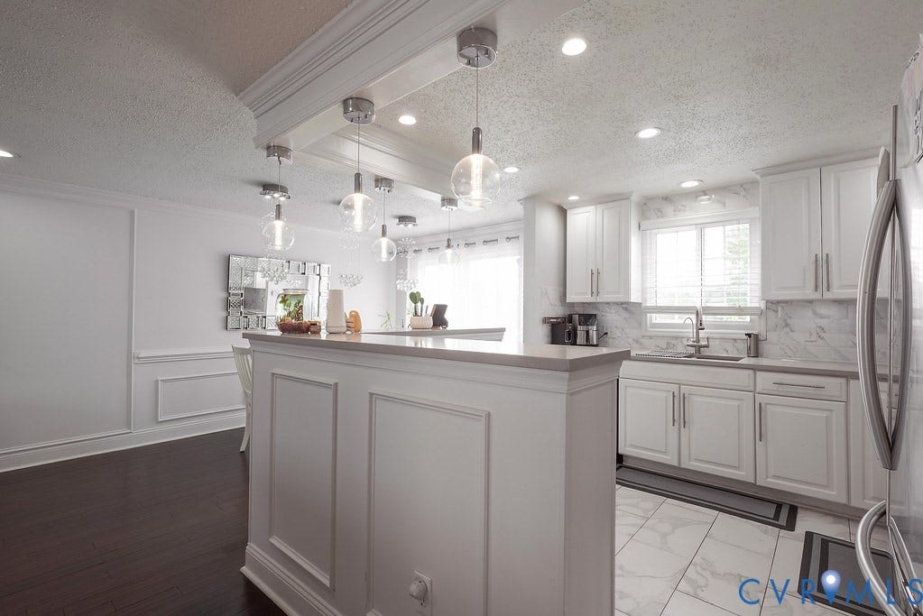Dark wood-finish flooring with white wainscoting