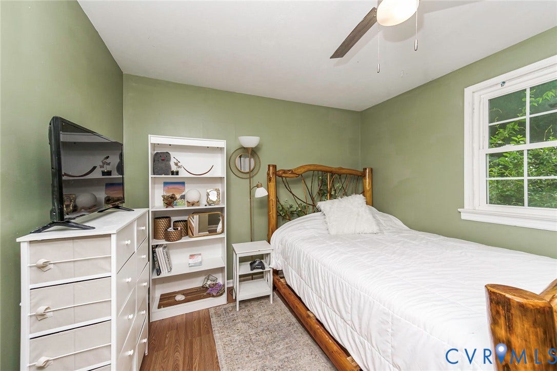 Wood-finish flooring, ceiling fan, and window