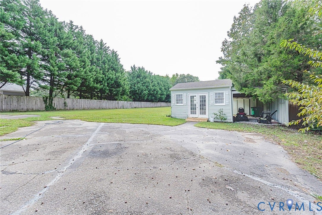 Rear yard, shed, and car port.