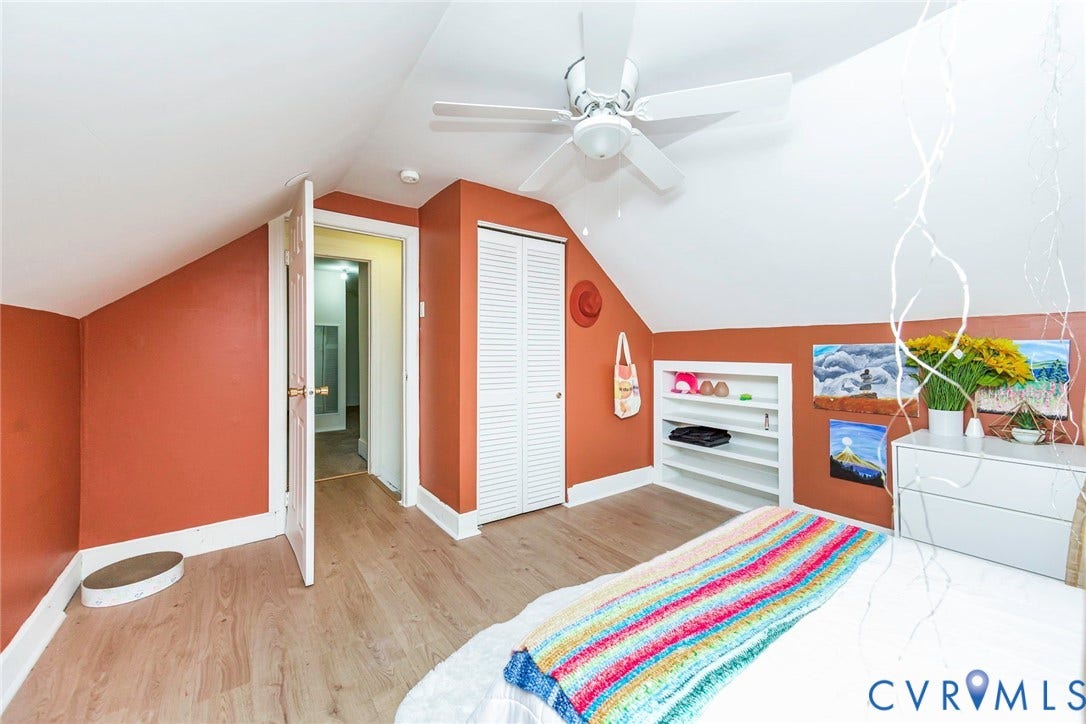 Sloped ceiling interior with wood-finish flooring
