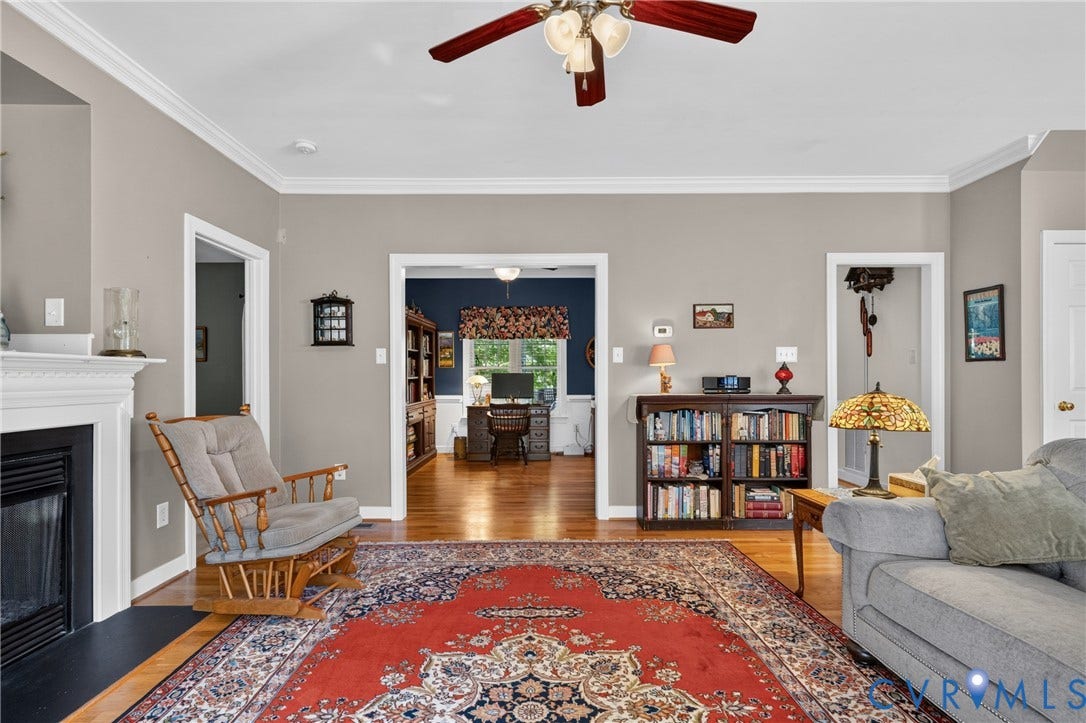 3647 Cedar Plains Road, Sandy Hook, Sandy Hook, VA 23153 Wood-finish flooring throughout, crown molding, fireplace with white mantel, and ceiling fan with integrated lighting