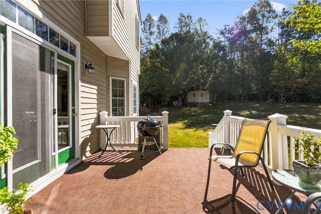 3647 Cedar Plains Road, Sandy Hook, Sandy Hook, VA 23153 Ground-level patio with direct exterior access, white railings, and a detached storage shed in the backyard