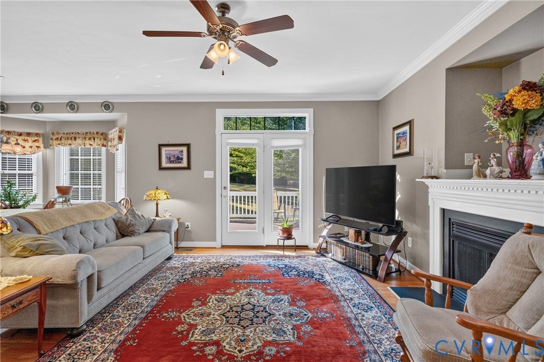3647 Cedar Plains Road, Sandy Hook, Sandy Hook, VA 23153 Hardwood flooring, crown molding, white fireplace surround, bay window, and exterior French doors
