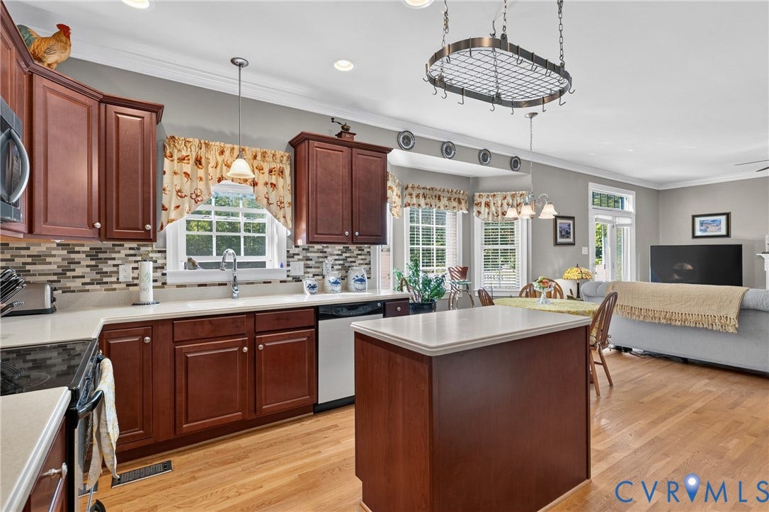 3647 Cedar Plains Road, Sandy Hook, Sandy Hook, VA 23153 Kitchen featuring wood cabinetry, light countertops, and a mosaic tile backsplash