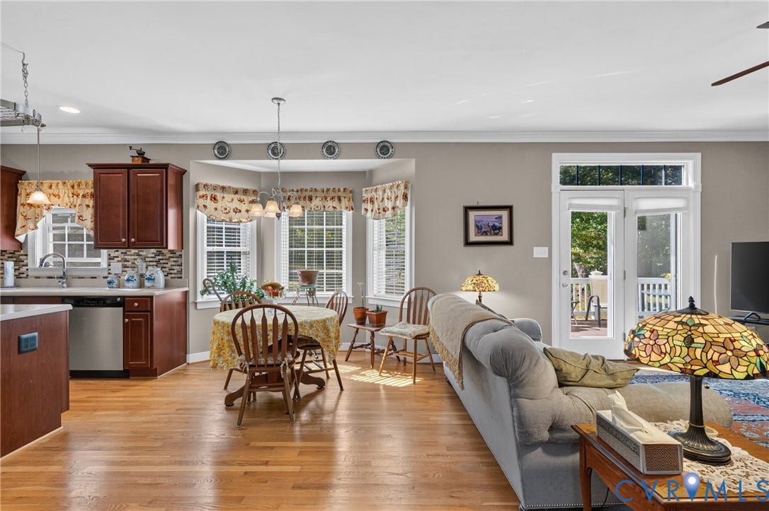 3647 Cedar Plains Road, Sandy Hook, Sandy Hook, VA 23153 Hardwood-style flooring throughout, kitchen with cherry wood finish cabinetry, stainless steel dishwasher, bay window with blinds, and French doors with transom
