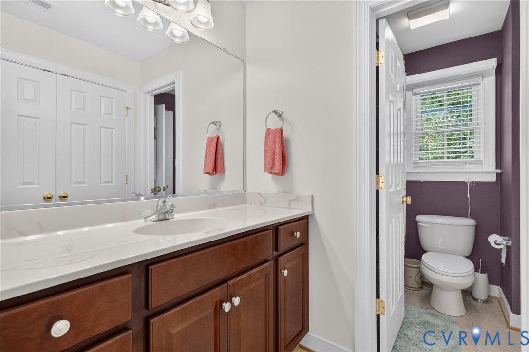 3647 Cedar Plains Road, Sandy Hook, Sandy Hook, VA 23153 Vanity with wood-finish cabinetry, integrated sink, and a spacious countertop