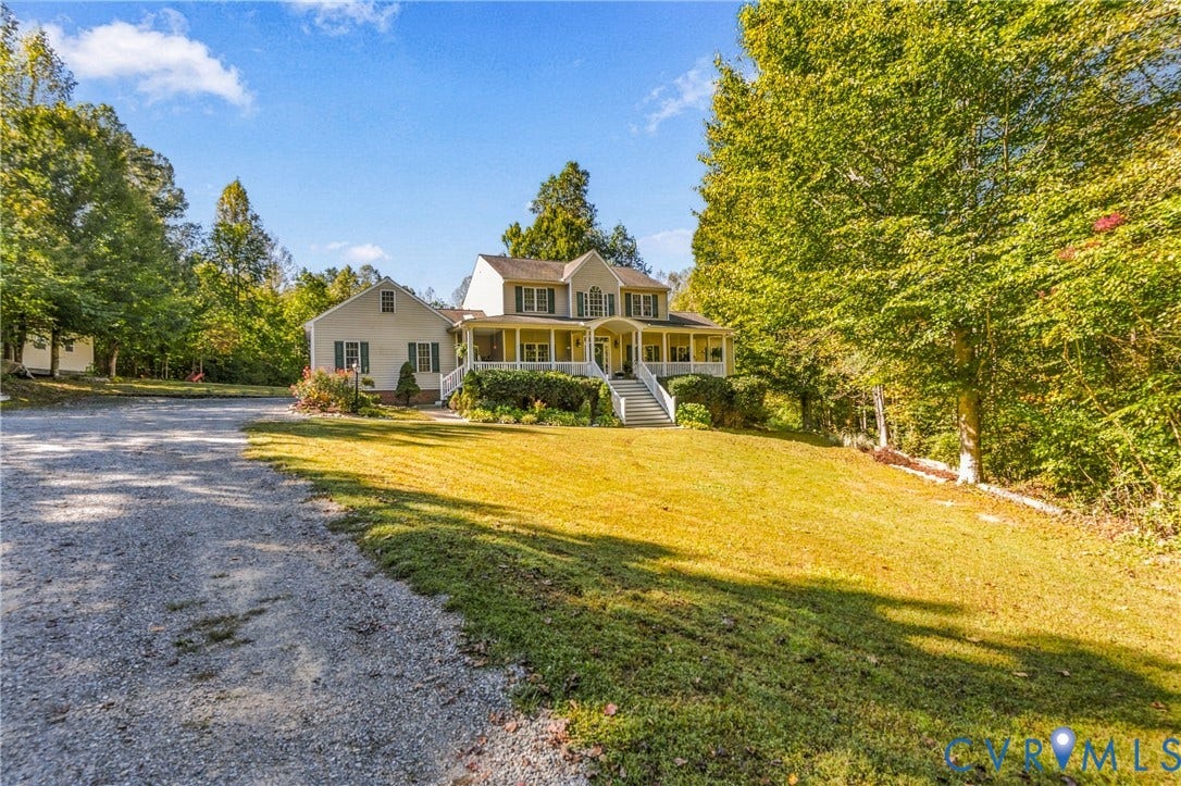 3647 Cedar Plains Road, Sandy Hook, Sandy Hook, VA 23153 Two-story colonial-style residence with a front porch, gravel driveway, and mature landscaping